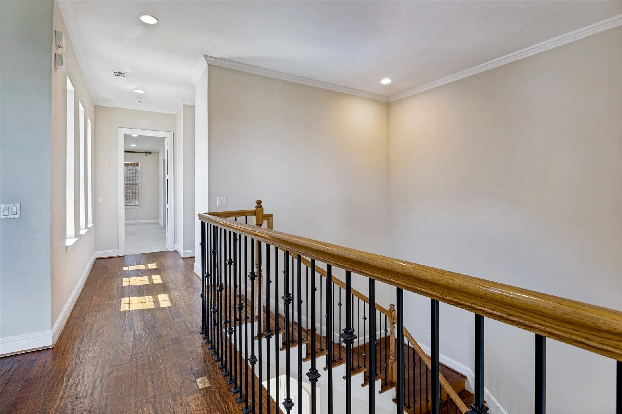 Light filled hallway with an abundance of windows overlooking the interior courtyard.