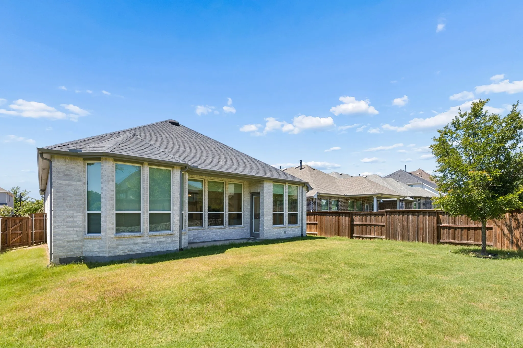 Wall of windows allows you to fill your home with natural light  and electric shades to cool the home during the summer heat