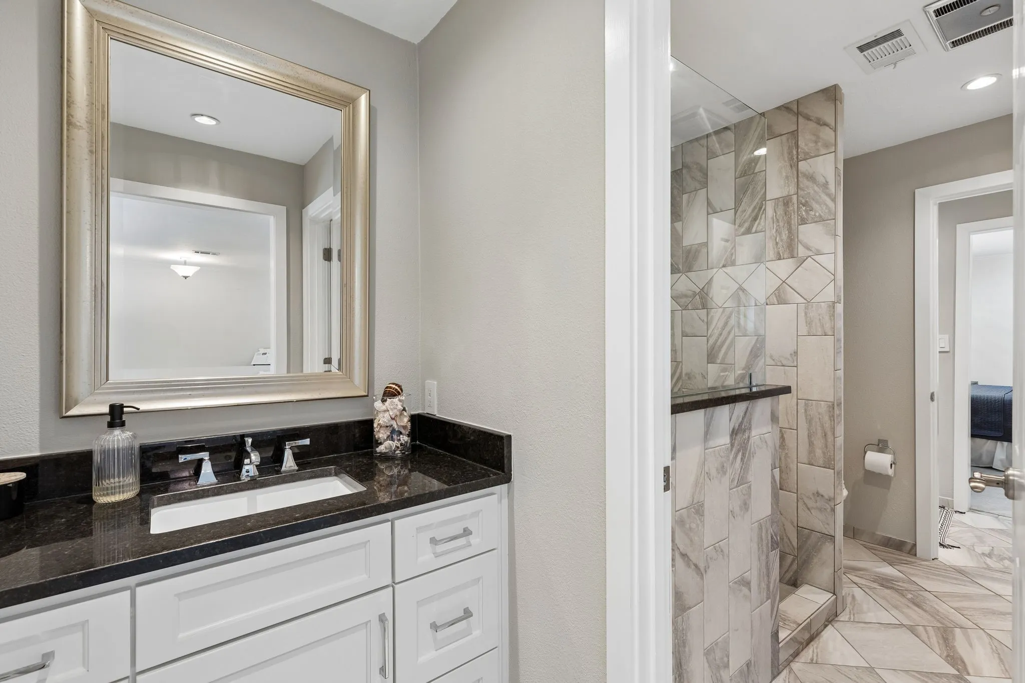 Another beautifully updated bathroom with pocket doors connecting for privacy.