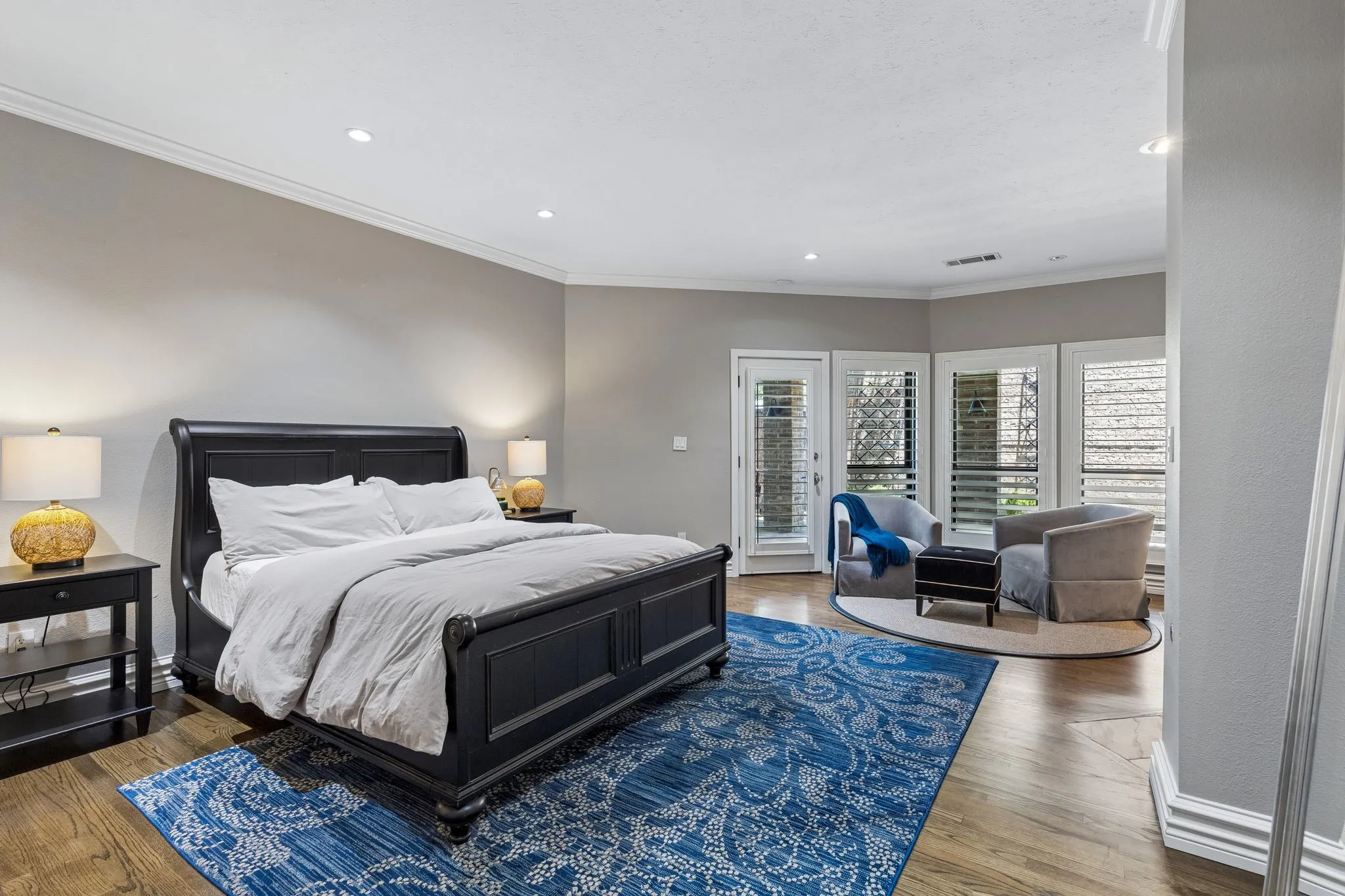 The primary retreat is calming and warm with sitting area and fireplace, and has access to the backyard.
