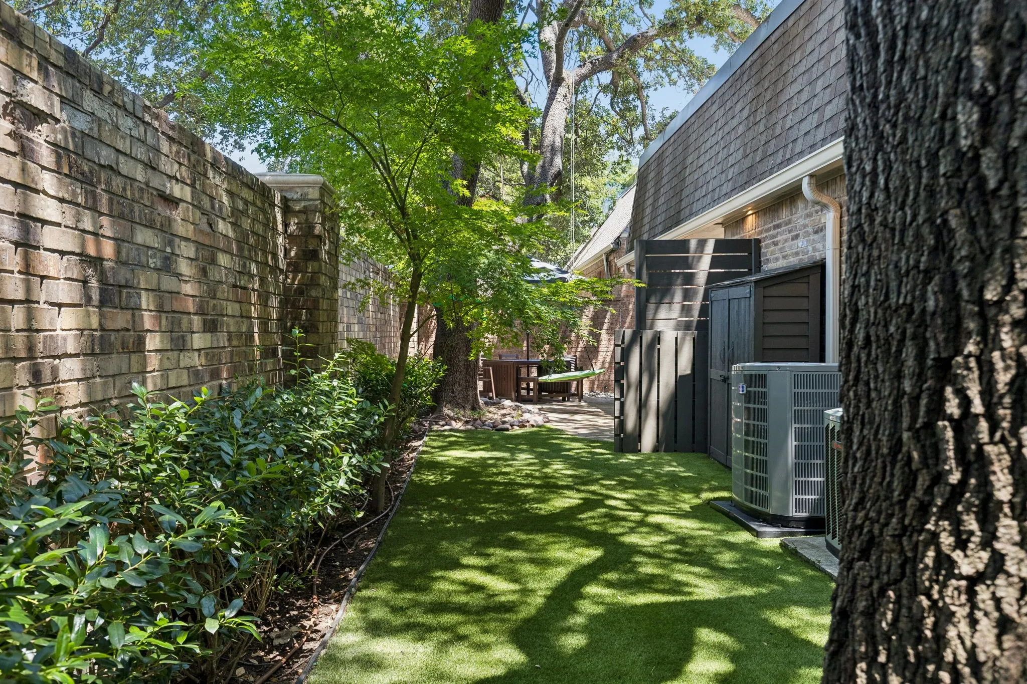 In addition to the oak trees, there are beautiful shrub hedges and japanese maple trees.