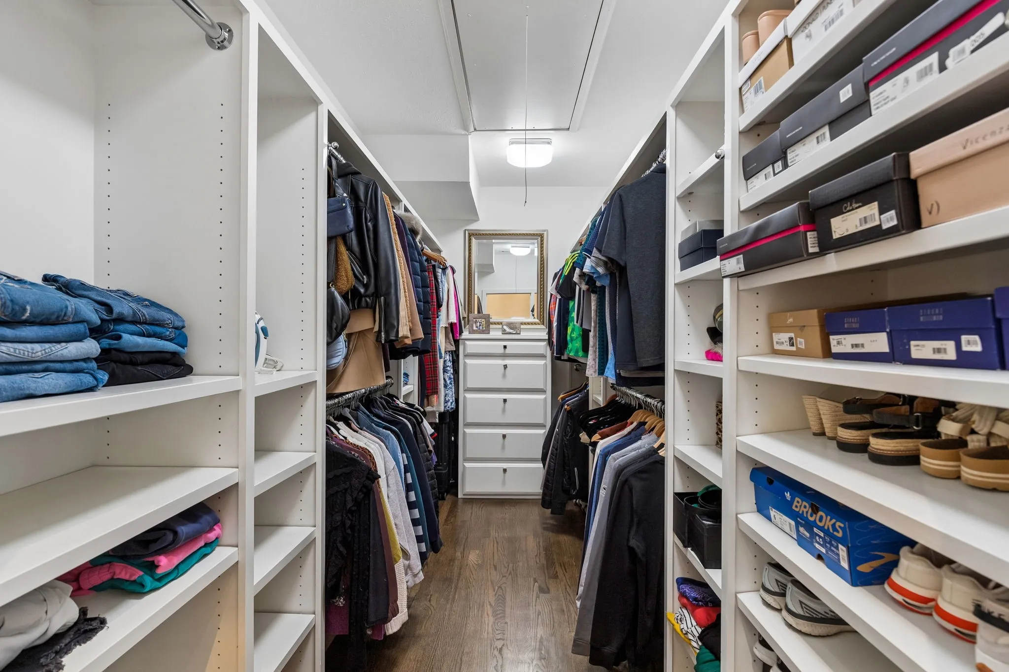 The primary closet is unusually big for this neighborhood. Built-in shelving and drawers help with space optimization.
