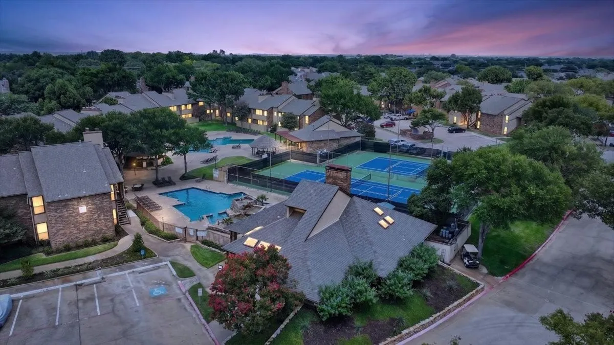 Community with multiple swimming pools, tennis courts, and mature trees