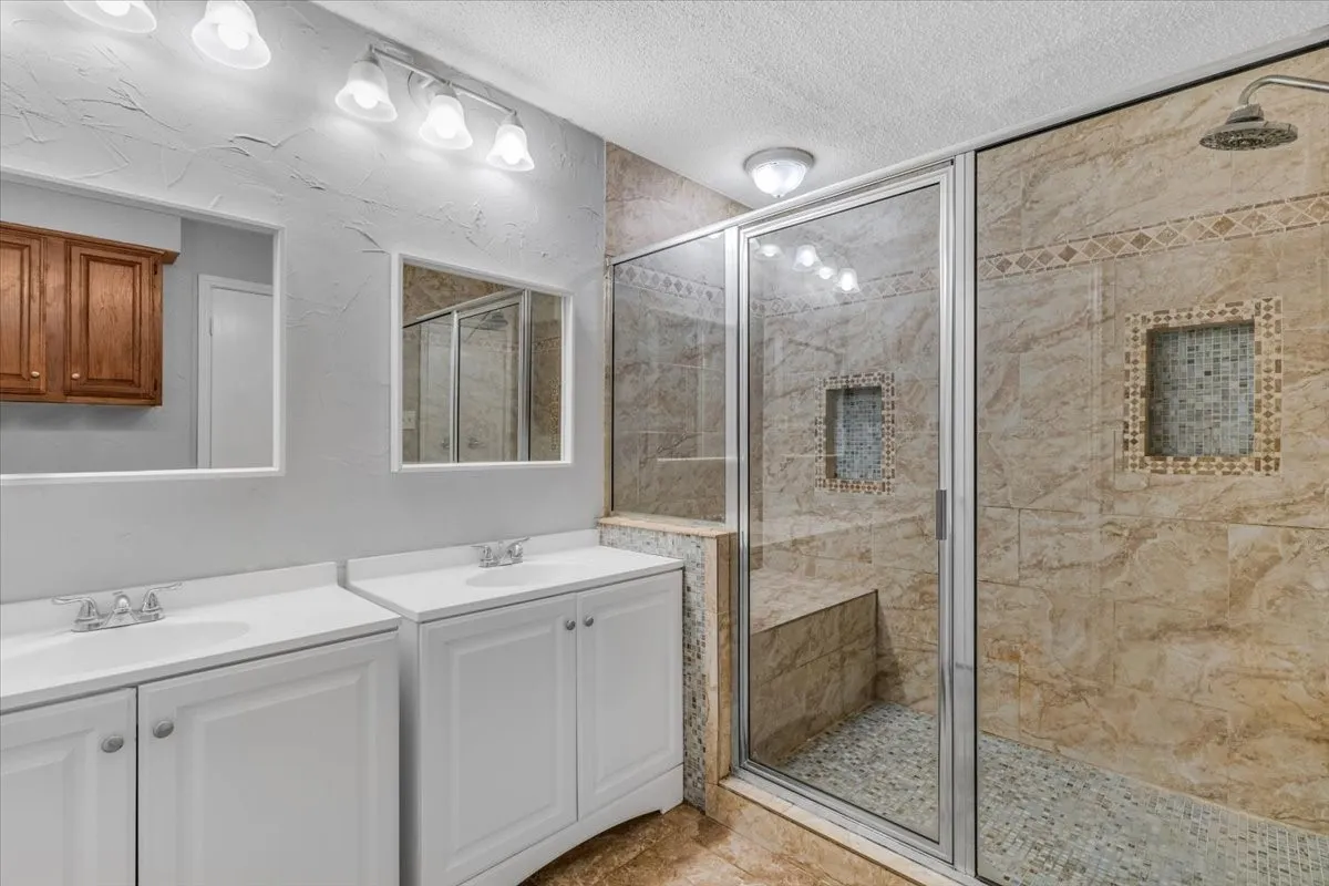 Dual vanity with white cabinetry and integrated sinks.