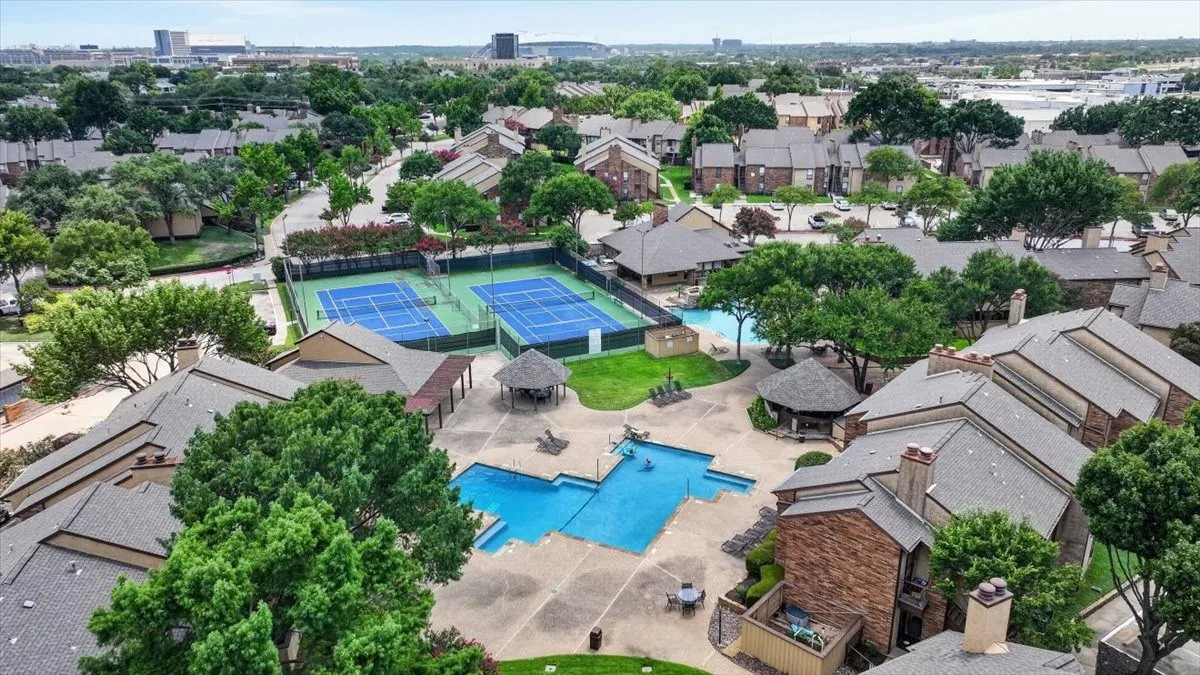 Resort-Style Community Amenities featuring Olympic-length lap pools with dedicated lane markers, resort-style leisure pool with shallow entry, professional-grade tennis courts, mature landscaping with native trees throughout the community, and luxury residential architecture with multiple architectural styles visible across the neighborhood