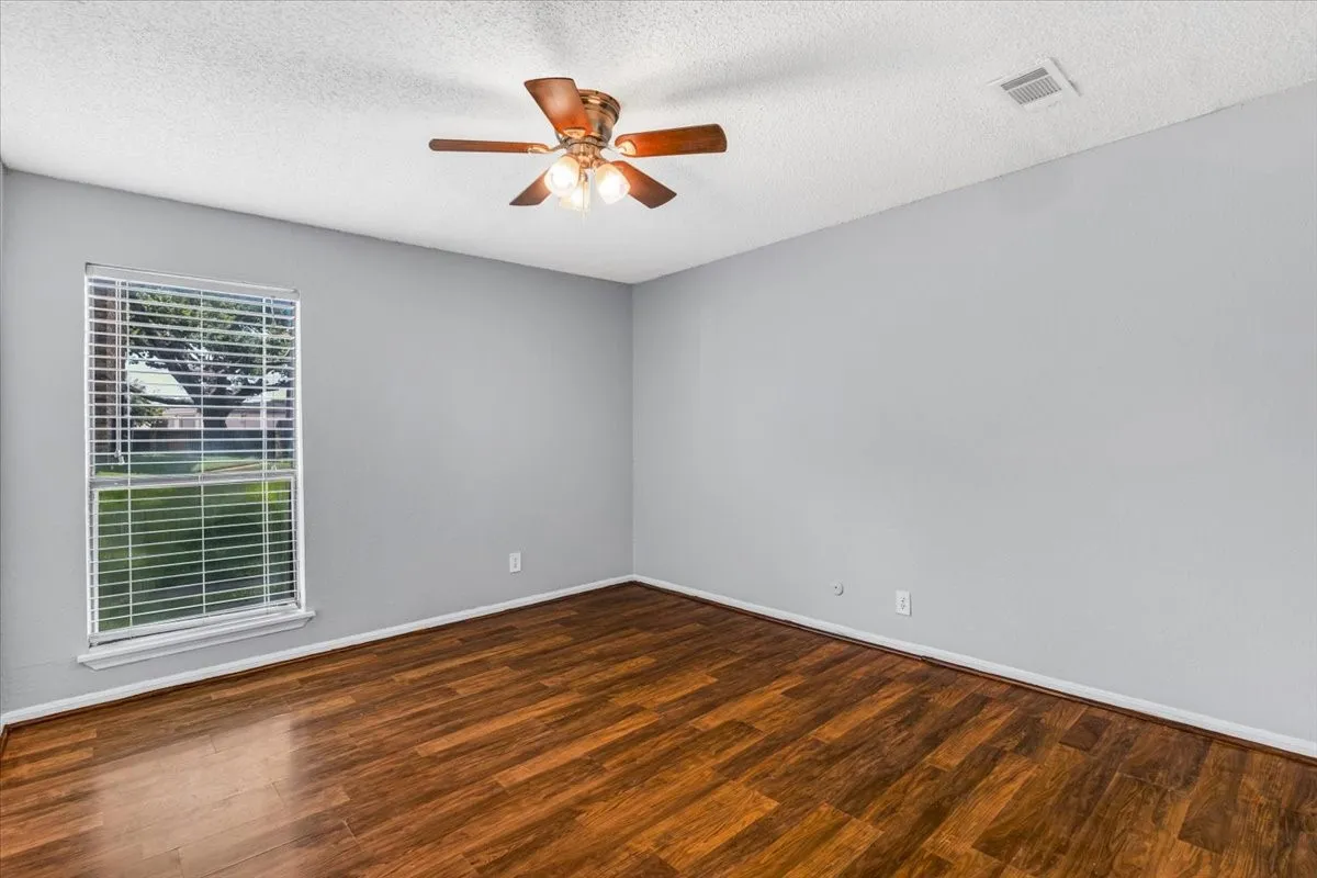 Room featuring a wood-finish floor and light gray walls