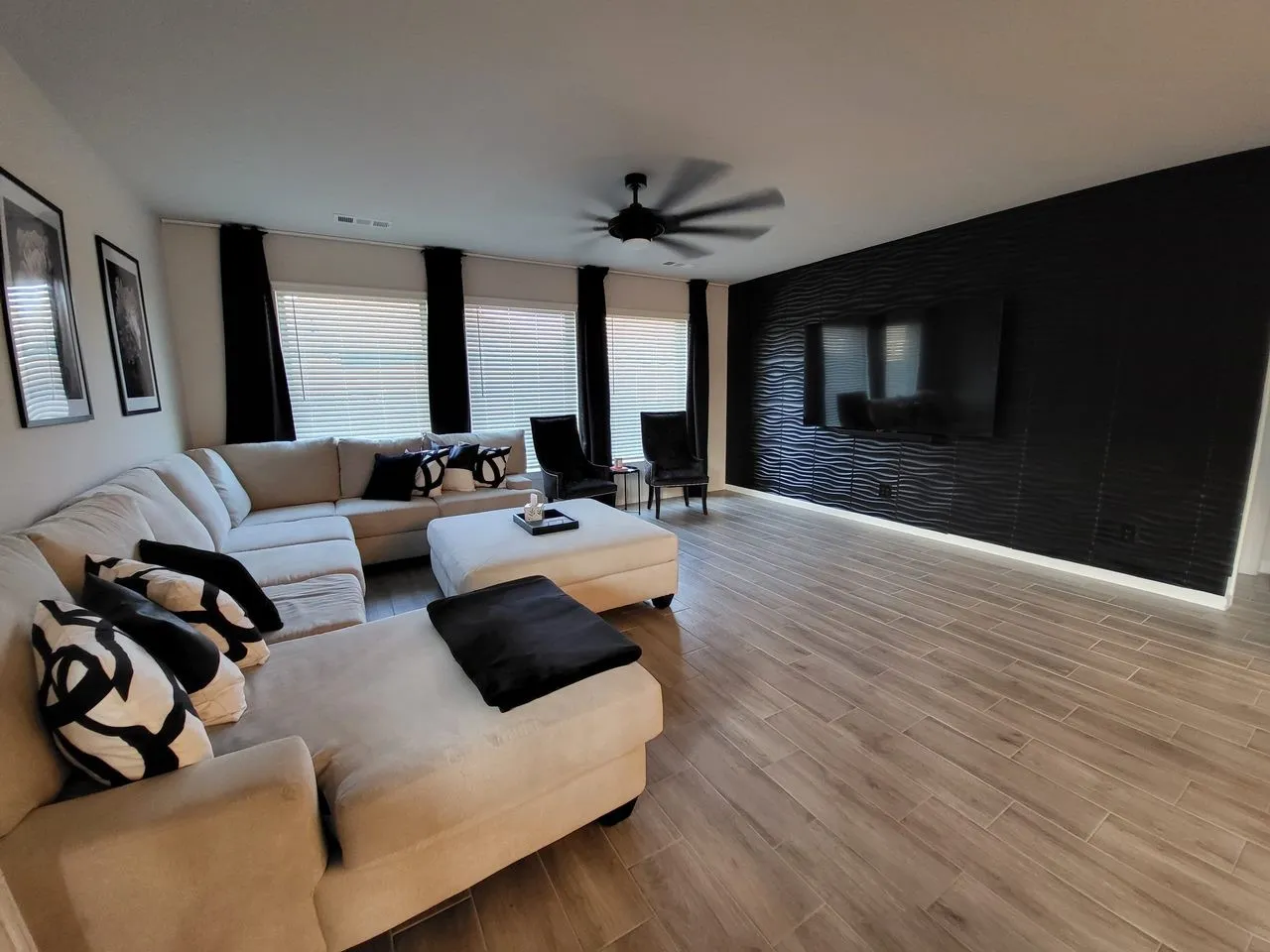 Living room with ceiling fan and light wood-type flooring