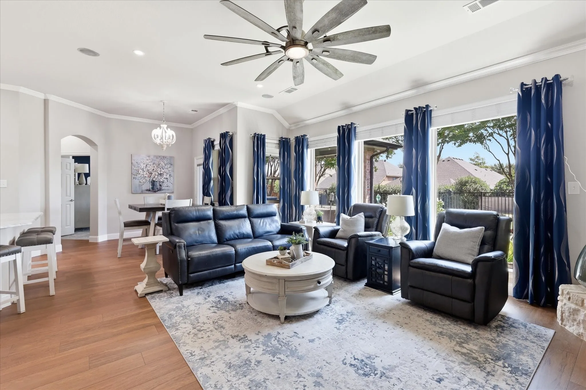 Recessed lighting, wood-finish flooring, vaulted ceilings, crown molding, and large windows