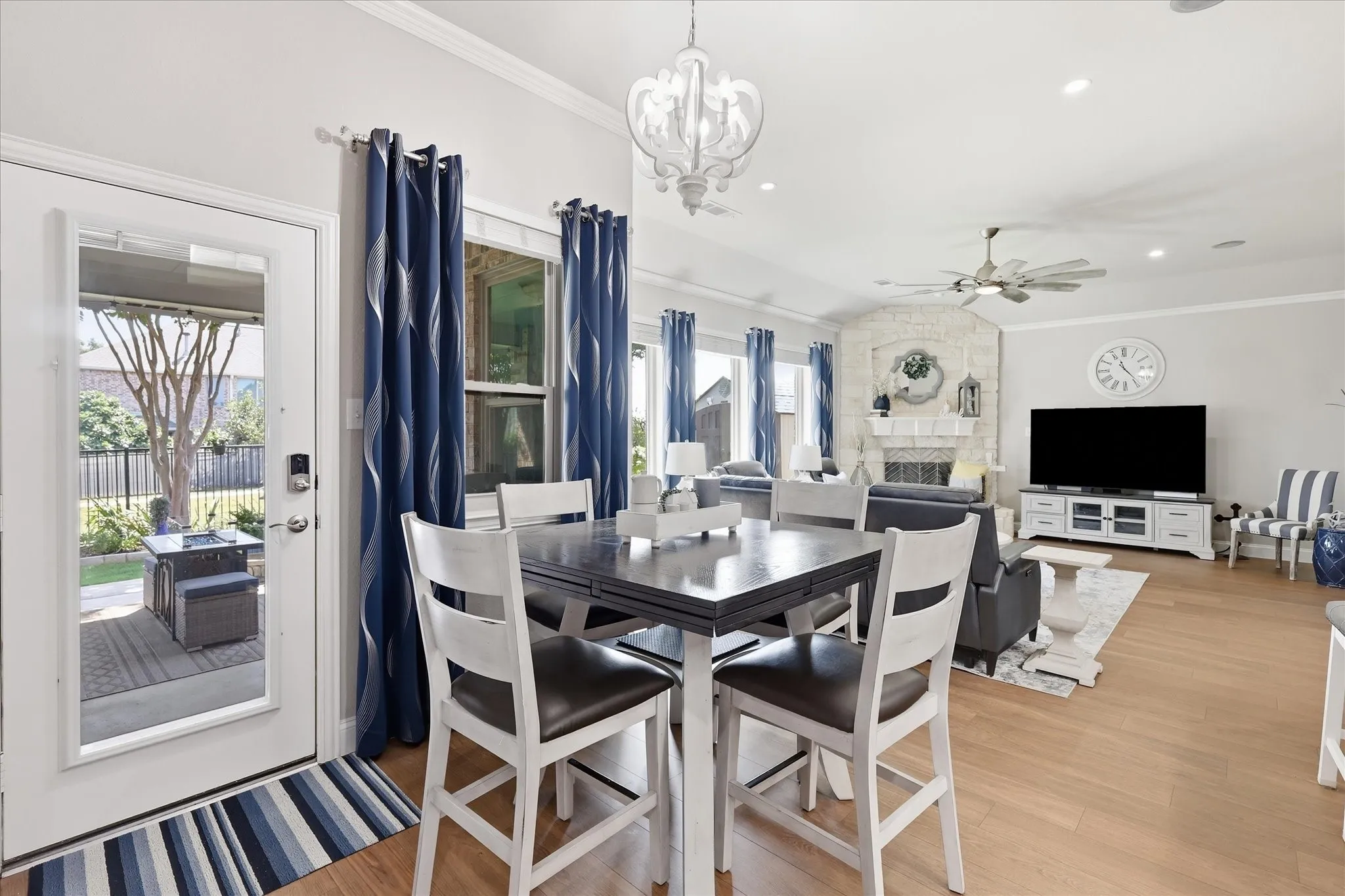 Hardwood-finish flooring, vaulted ceilings, a stone-clad fireplace, and a built-in media console