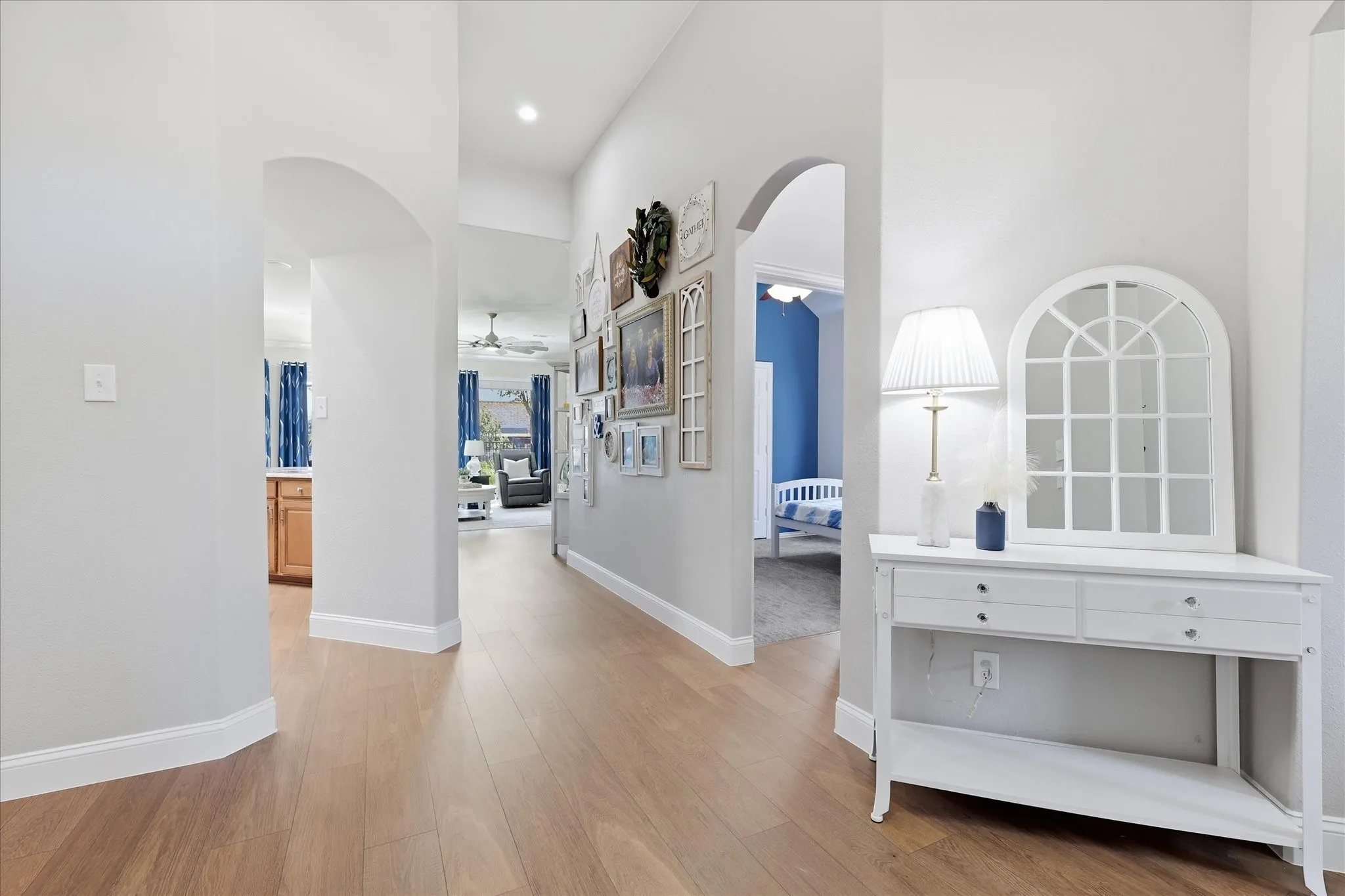 Wood-finish flooring throughout, complemented by arched doorways