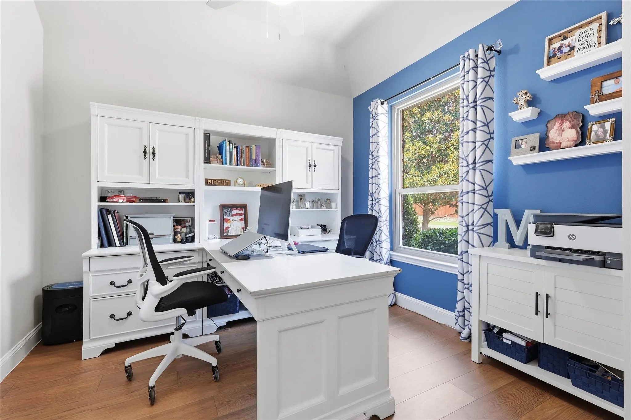 Built-in cabinetry, wood-finish flooring, ample natural light, and a dedicated workspace