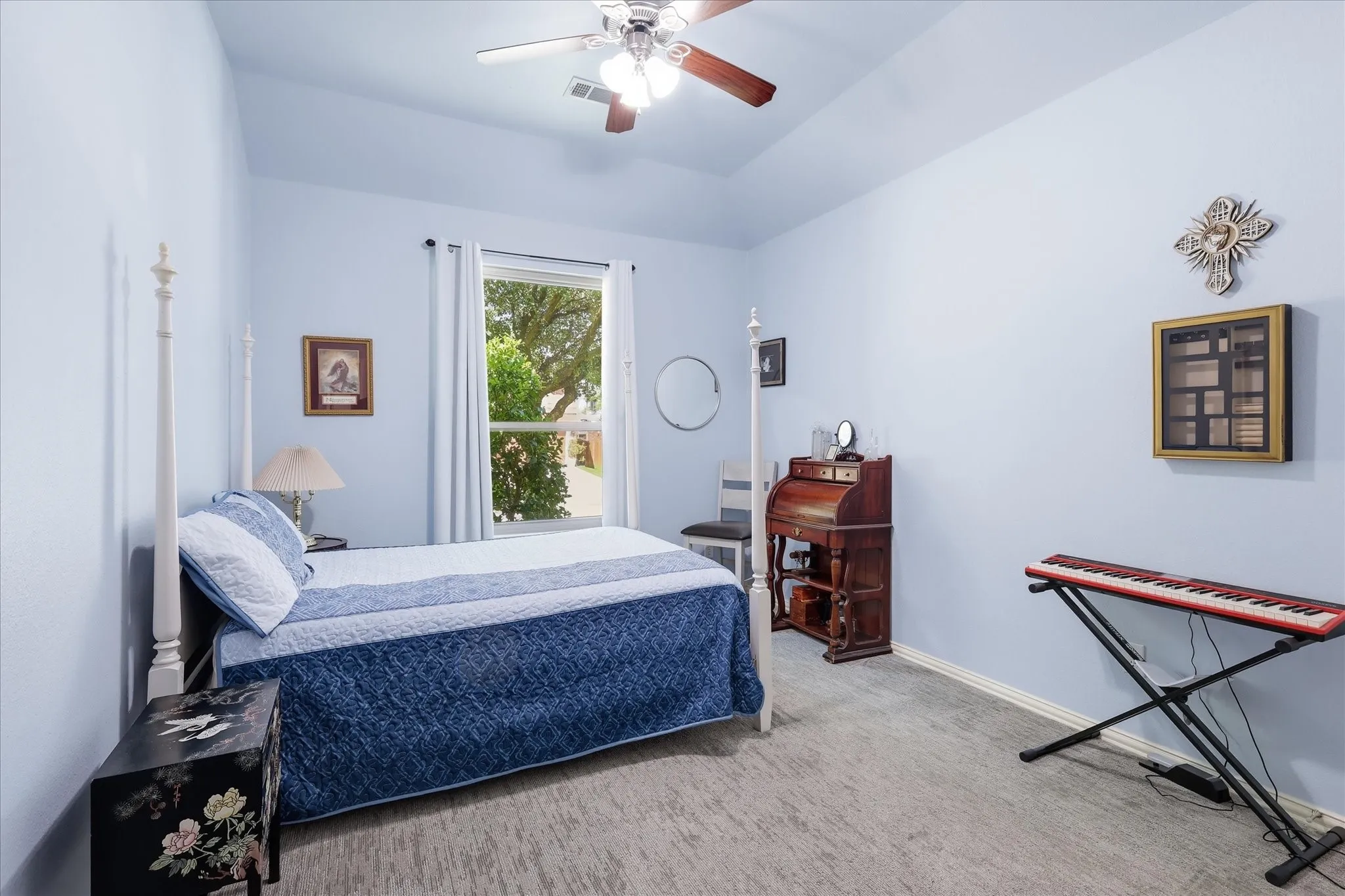 Vaulted ceiling with a ceiling fan, window with curtains, wood-finish flooring, and light blue wall paint