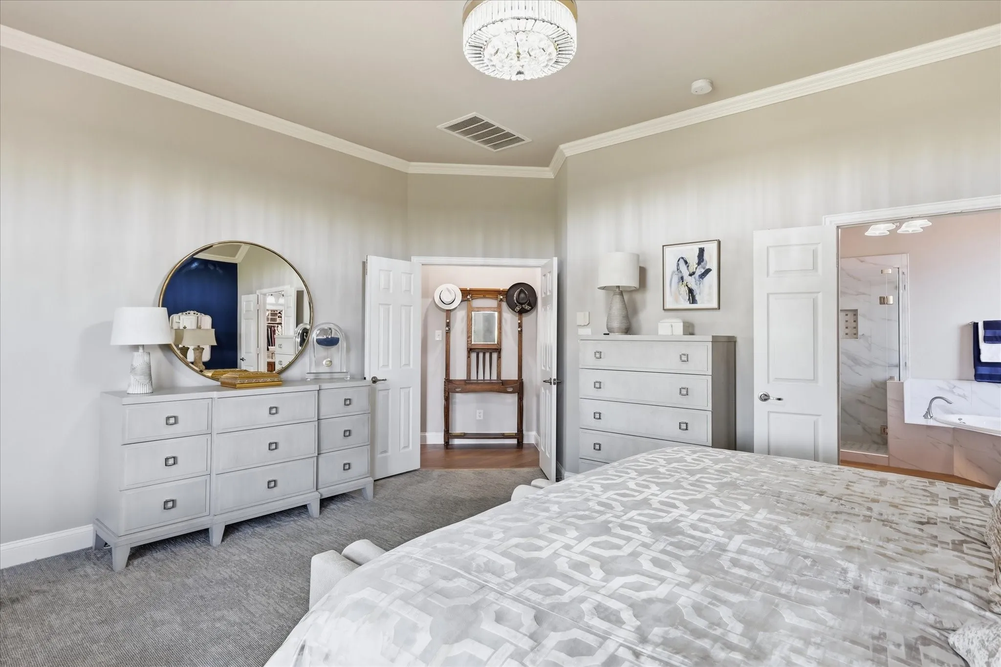 Recessed ceiling with crown molding, chandelier light fixture, recessed lighting, and carpet flooring