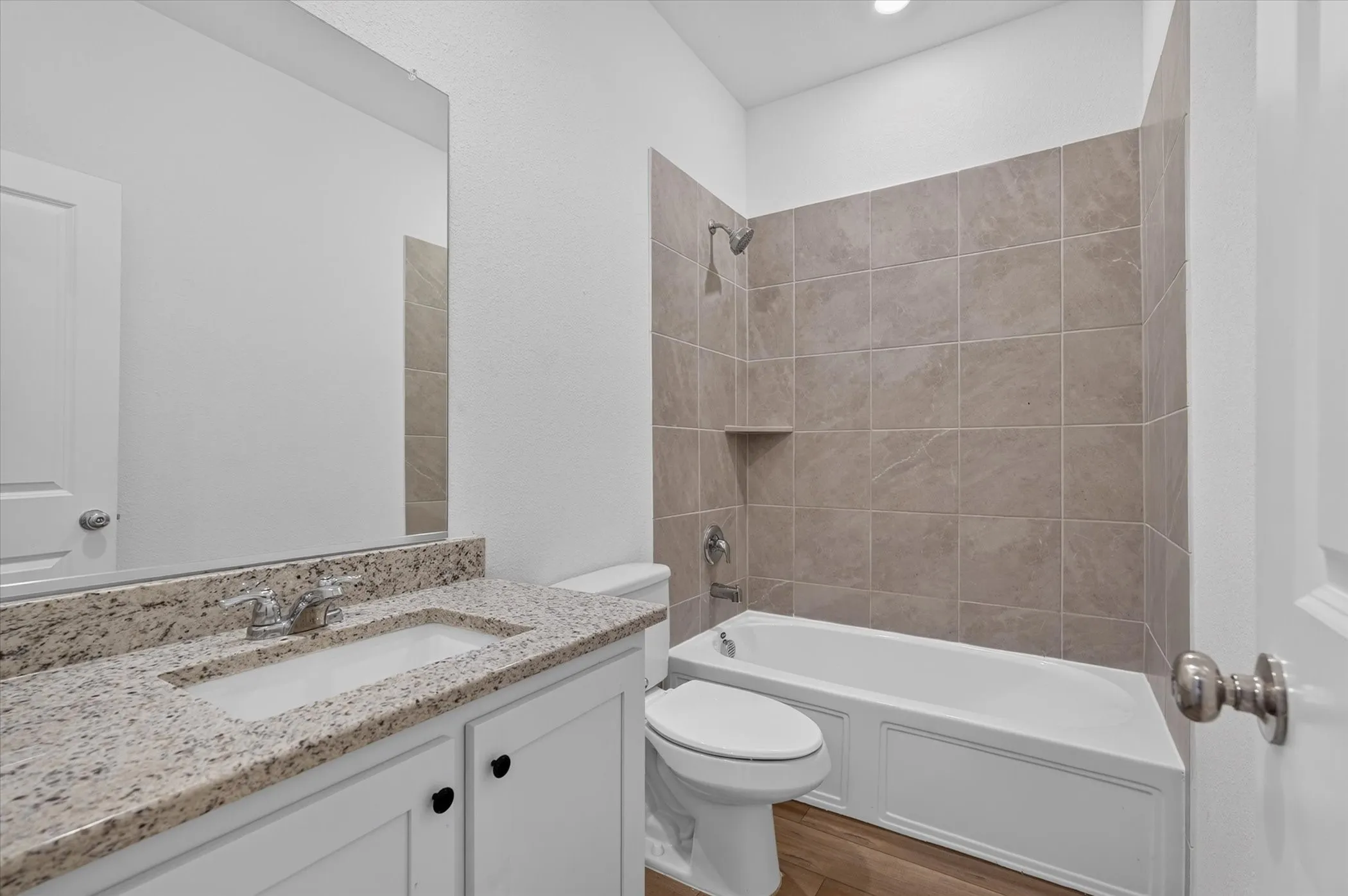 Bathroom featuring a white vanity with a granite countertop and an undermount sink