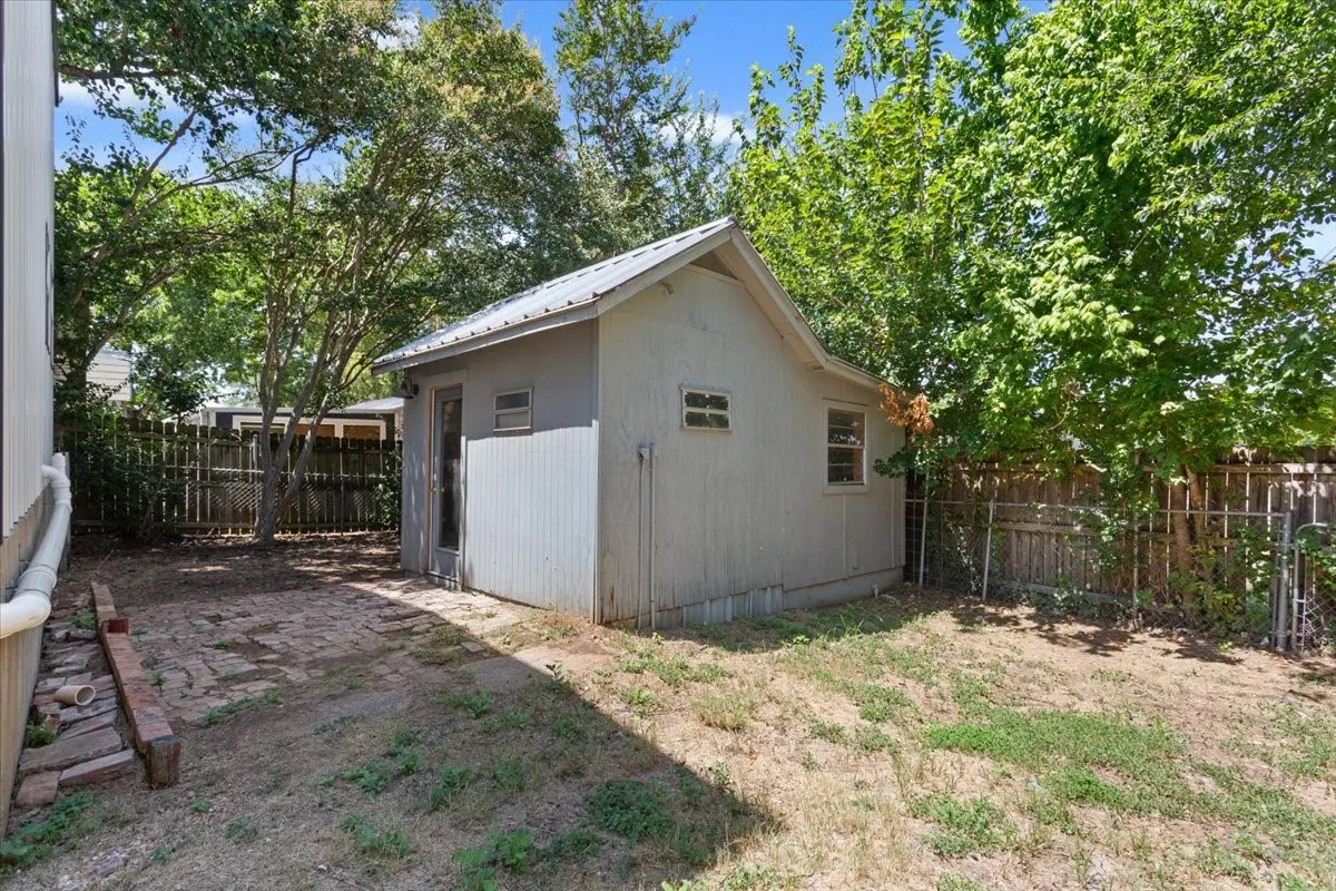 Shed #1.Detached storage shed featuring a metal roof and side window