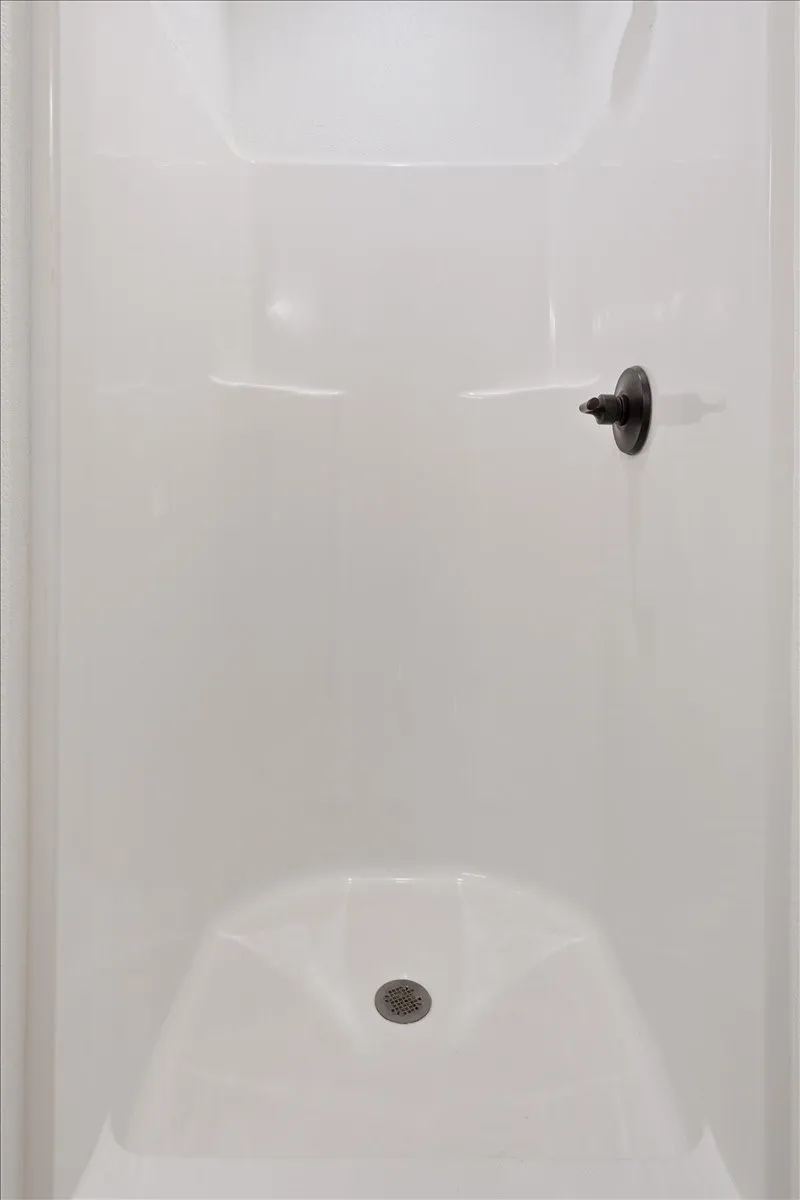Downstairs bathroom #2, attached to kitchen. Featuring standing shower.