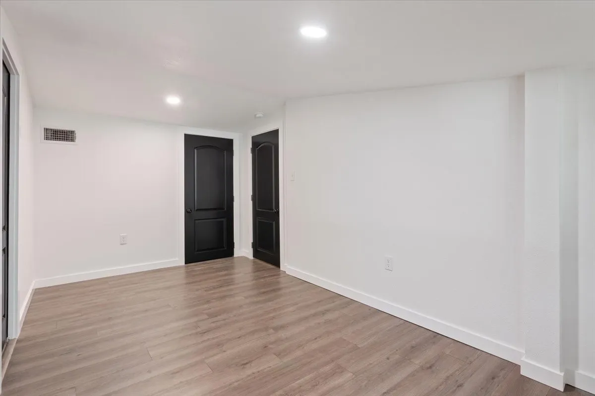 Second primary bedroom (upstairs) #2, showing door to stairway and attic access.