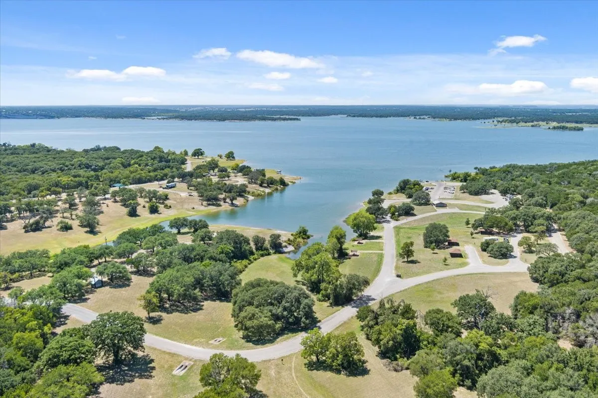 Expansive waterfront image featuring mature trees and established roadways