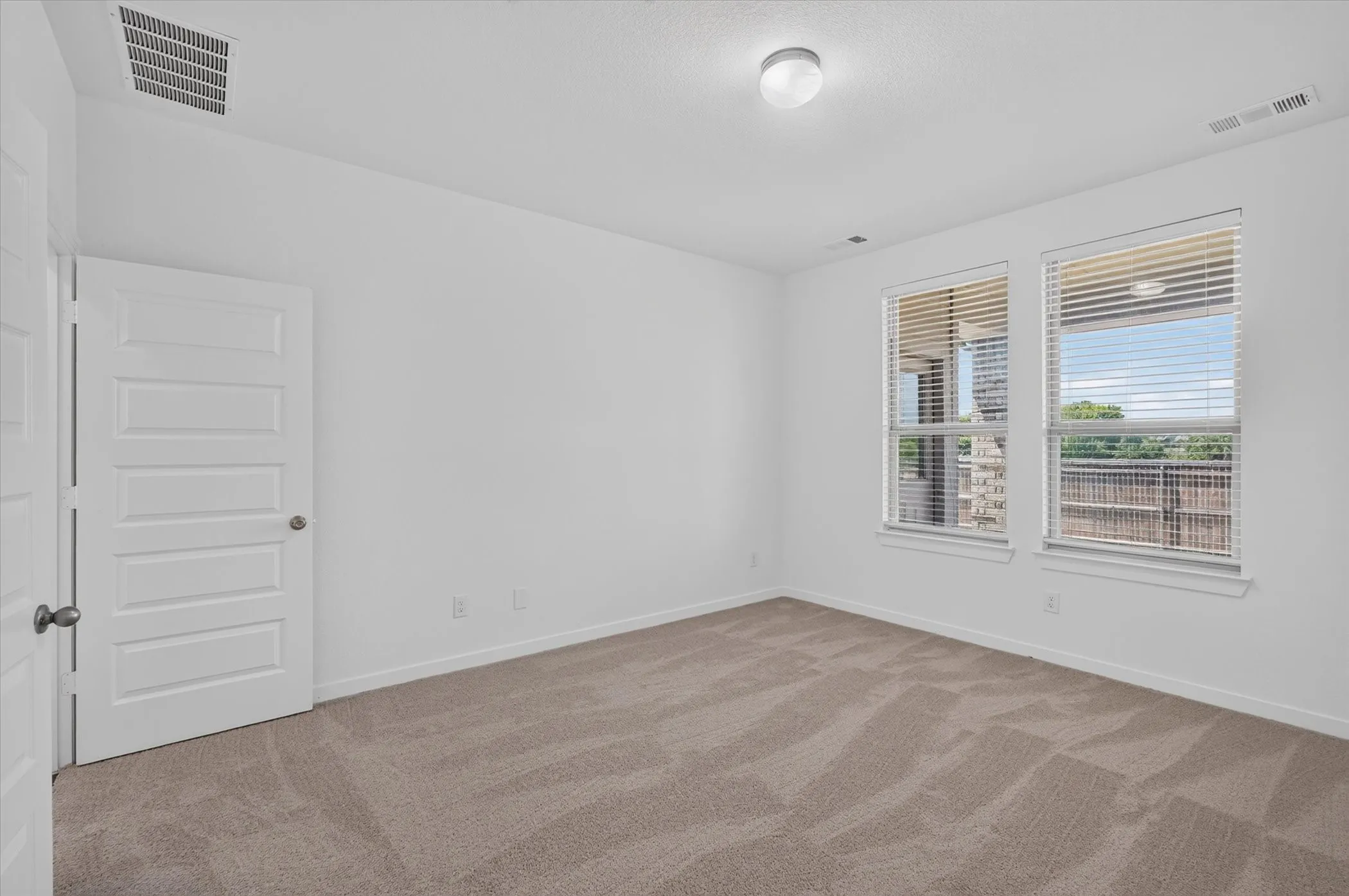 Neutral-toned carpeting paired with bright white walls
