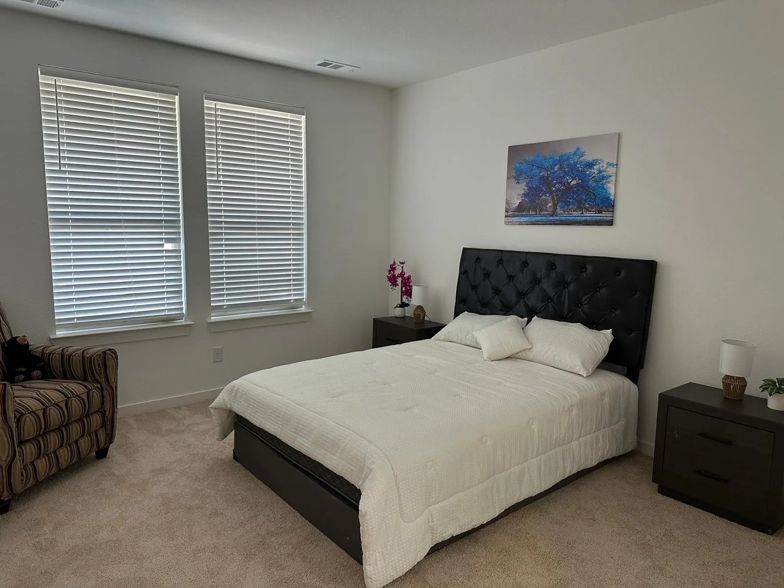 Neutral wall tones complement carpeted flooring throughout