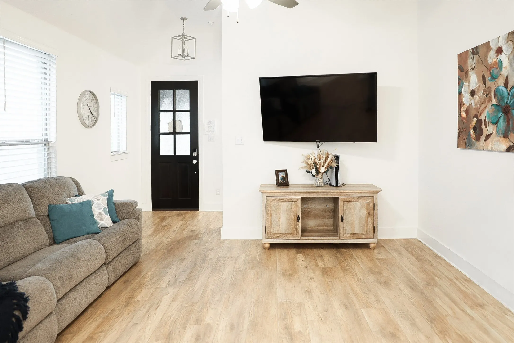 Spacious room featuring light wood-finish flooring