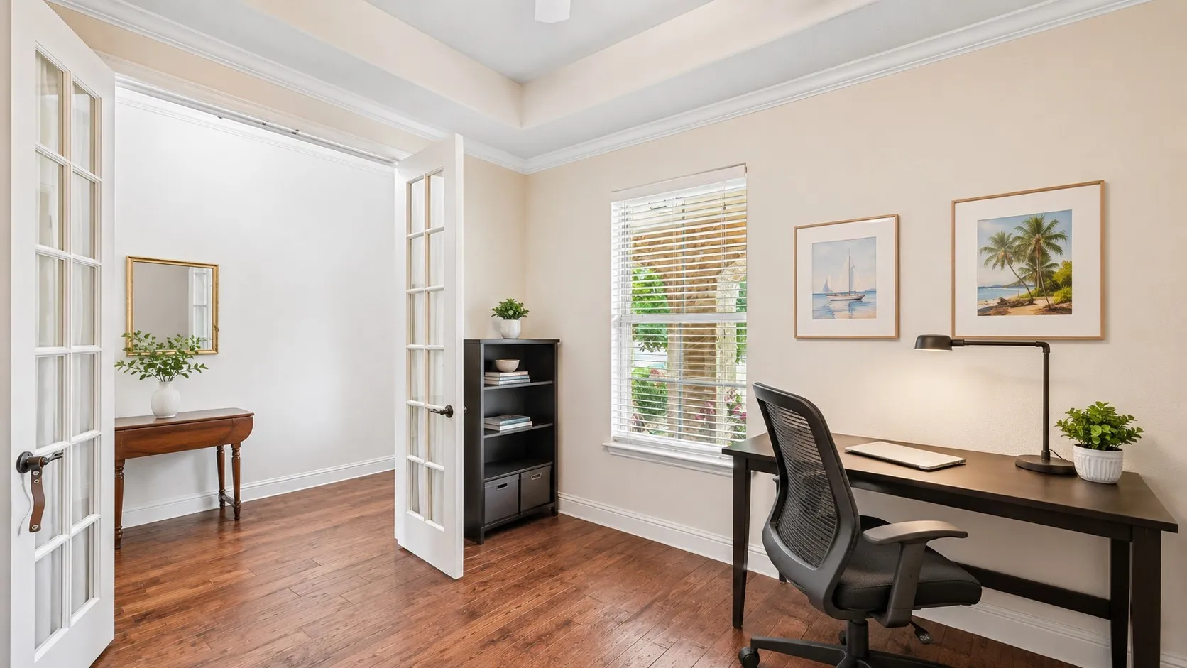 Office at entry of home featuring French doors and wood flooring