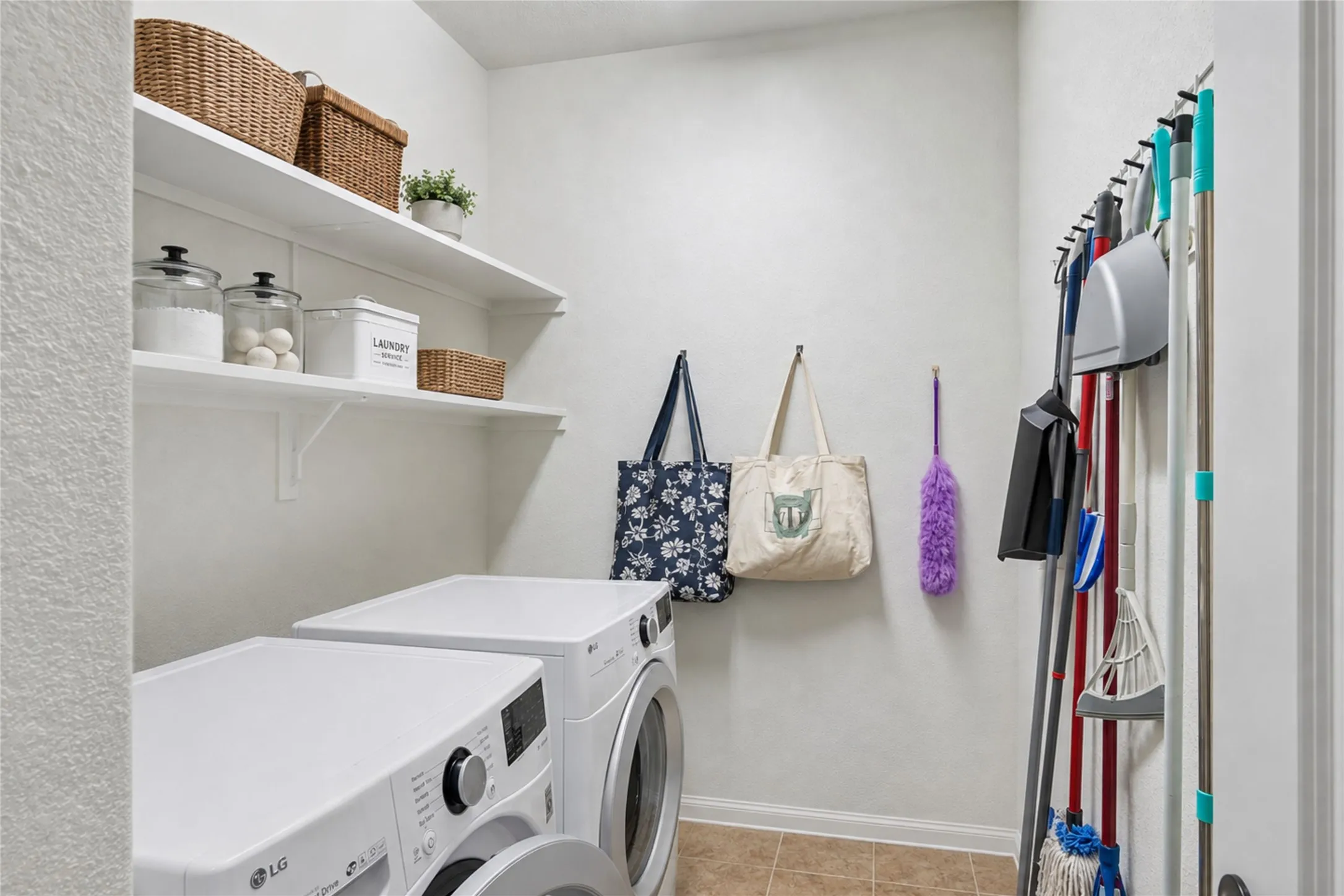 Dedicated laundry room featuring built-in shelving