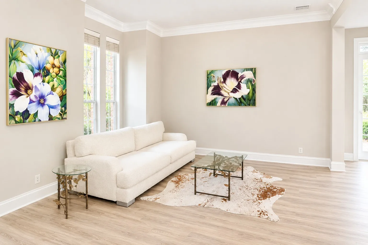 Light-filled interior space featuring wood-finish flooring, tall windows, crown molding, and a neutral color palette