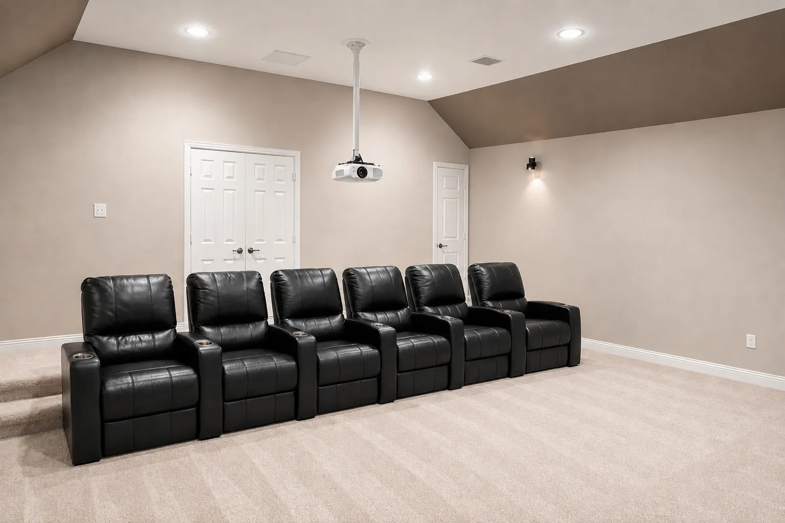 Dedicated media room featuring recessed lighting, a ceiling-mounted projector, and wall sconces