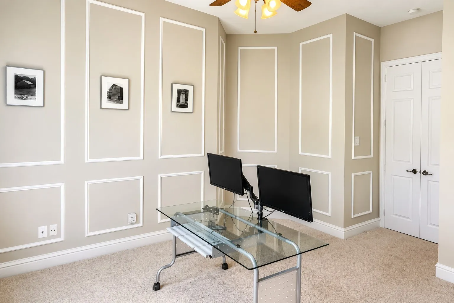 Neutral-toned interior room featuring decorative wall molding and a neutral carpet