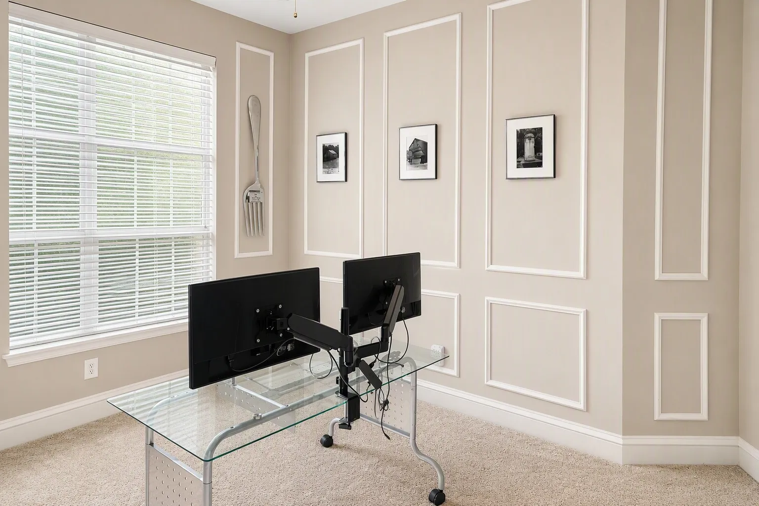 Room featuring decorative wall molding, a large window with blinds, and beige carpet flooring