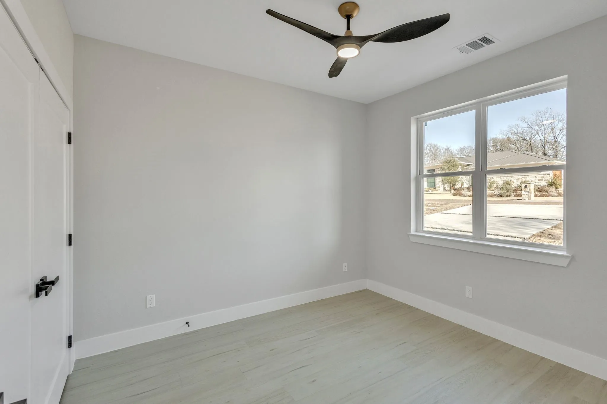 Spare room with light hardwood / wood-style floors and ceiling fan