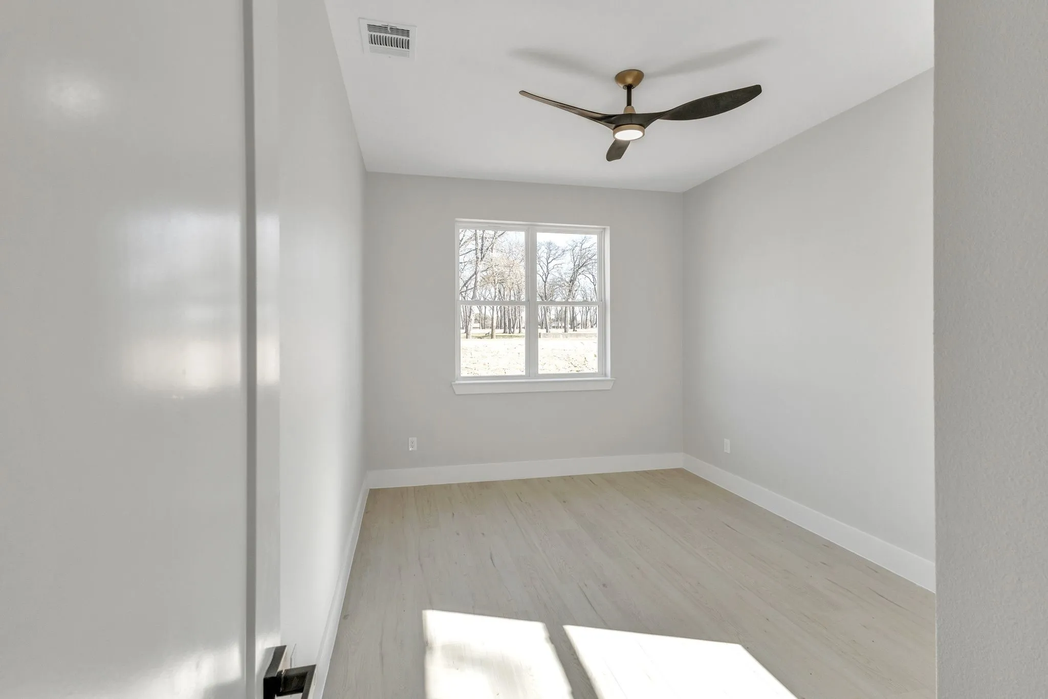 Spare room featuring light hardwood / wood-style flooring and ceiling fan