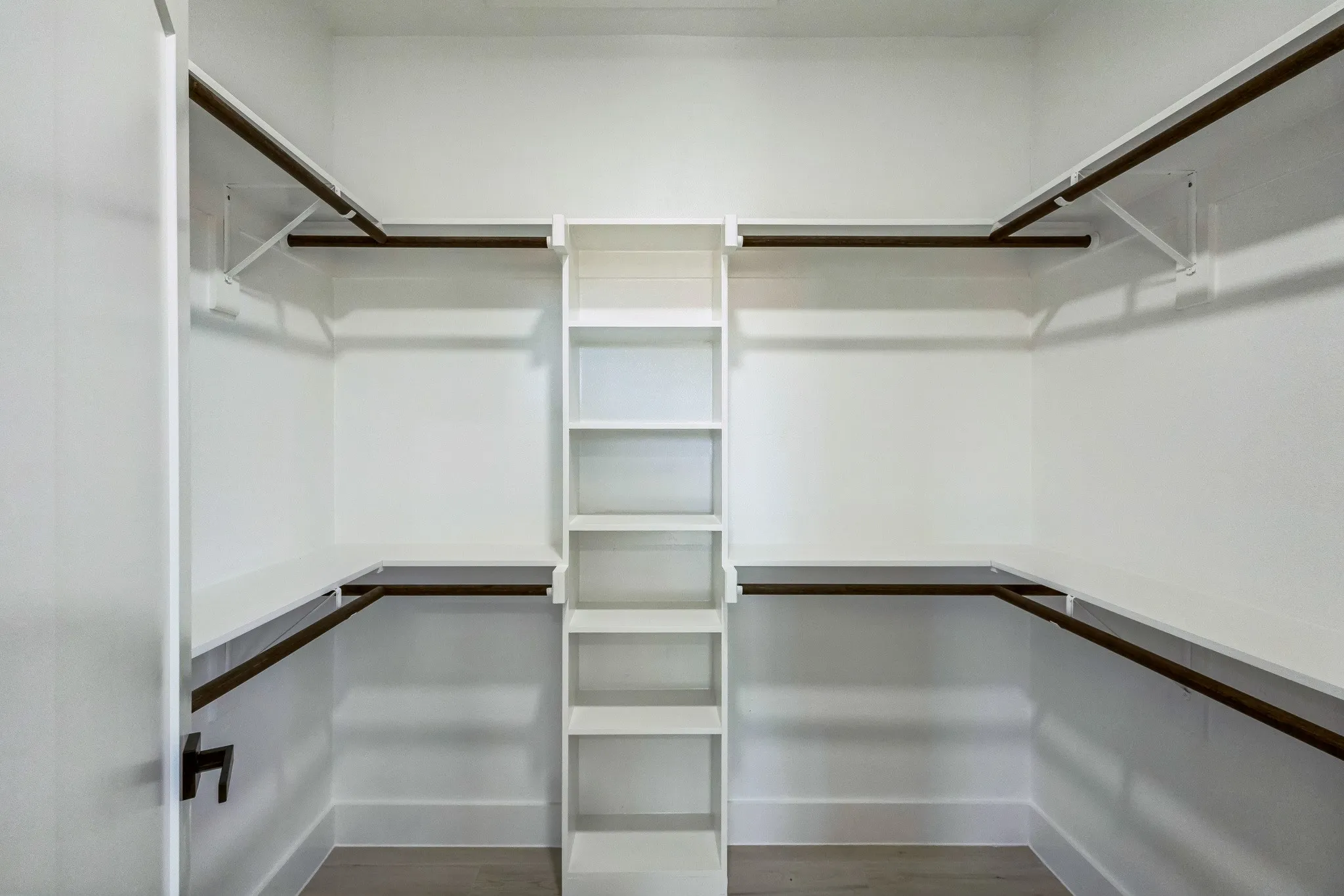 Spacious closet featuring hardwood / wood-style floors