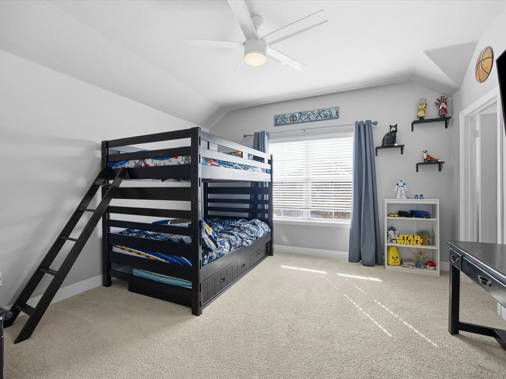 Bedroom with vaulted ceiling, light carpet, and ceiling fan