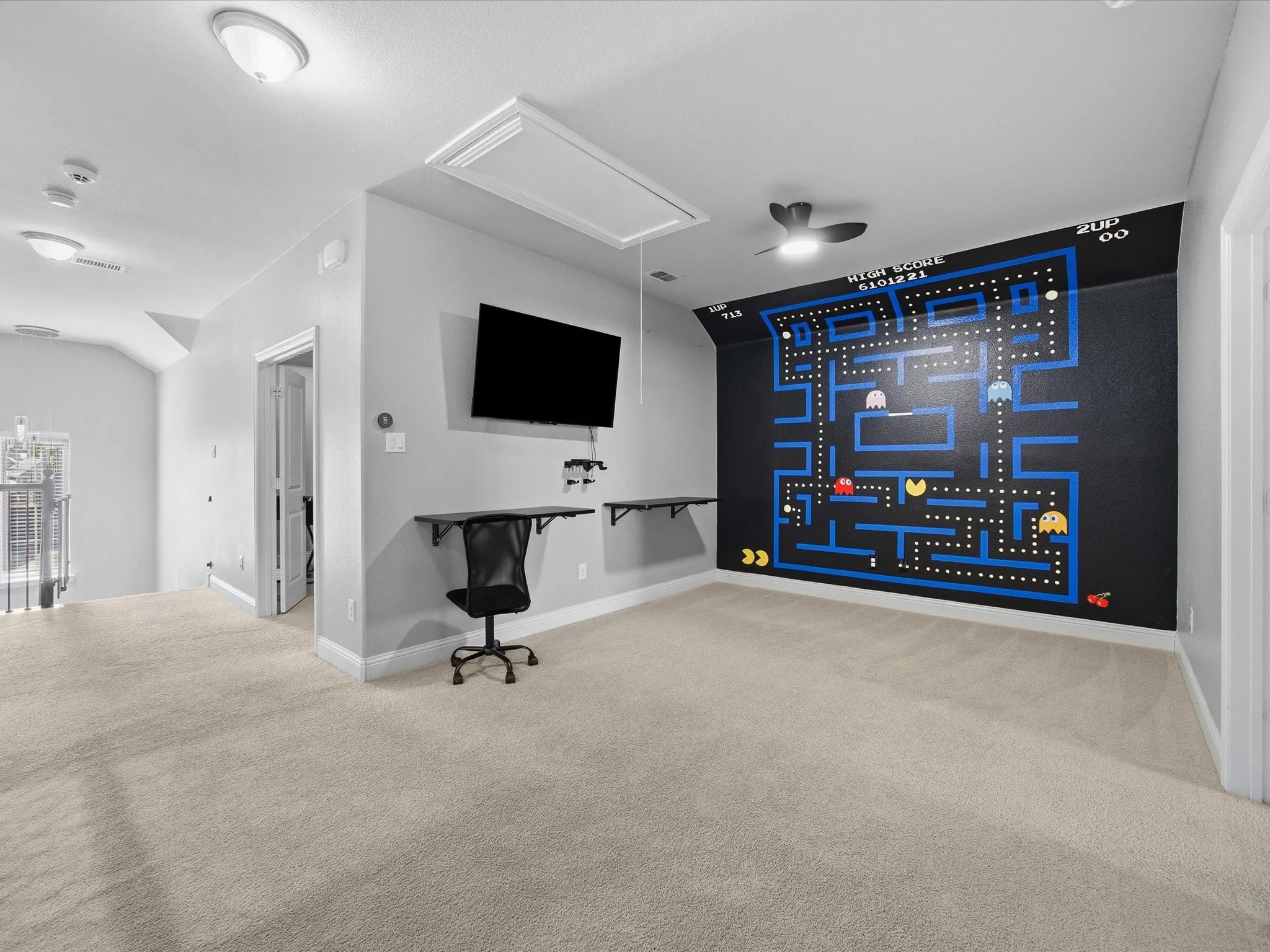 Carpeted home theater room with lofted ceiling
