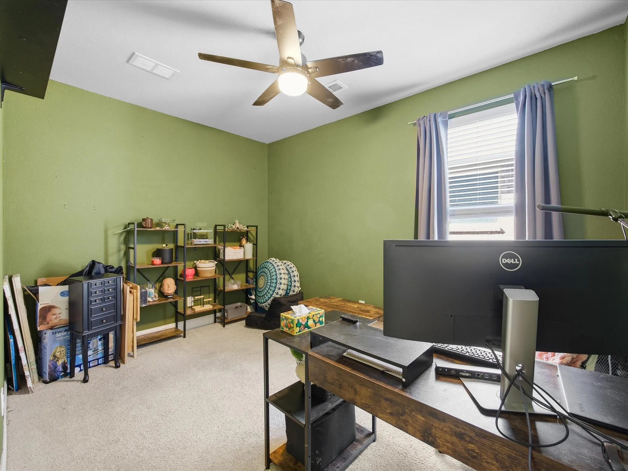 Carpeted office space with ceiling fan
