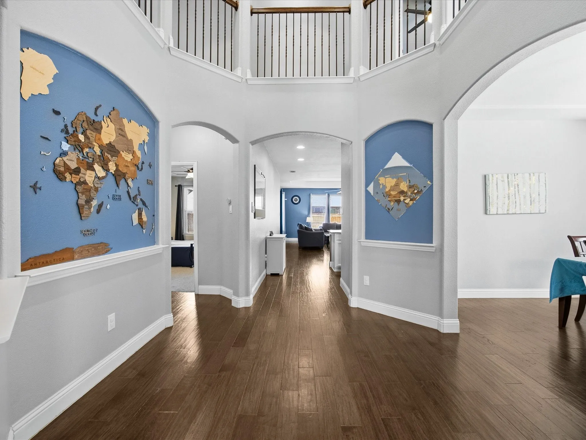 Corridor featuring arched walkways, dark wood-type flooring, a high ceiling, and recessed lighting