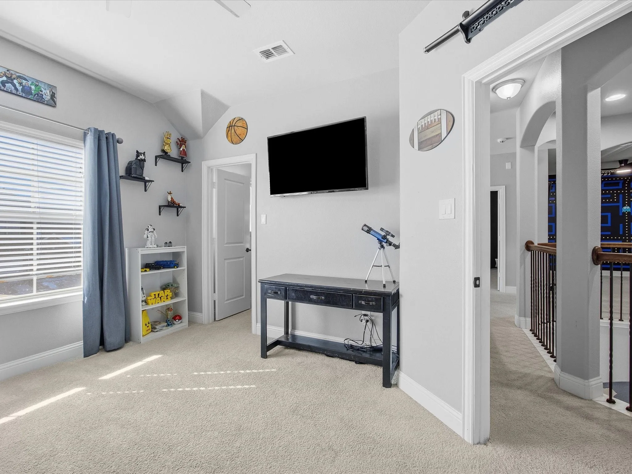 Bedroom featuring light colored carpet, a ceiling fan, vaulted ceiling, and arched walkways
