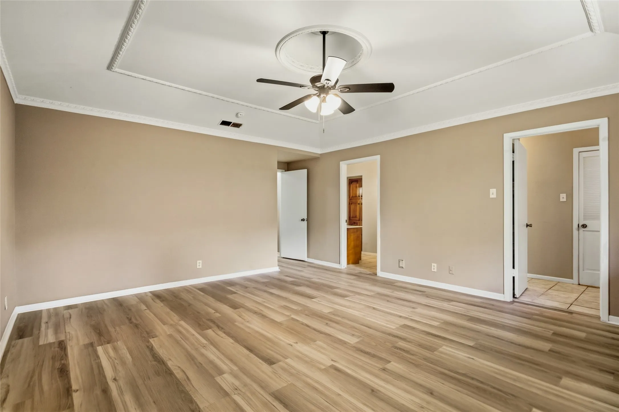 Wood-finish flooring with neutral wall tones and white trim