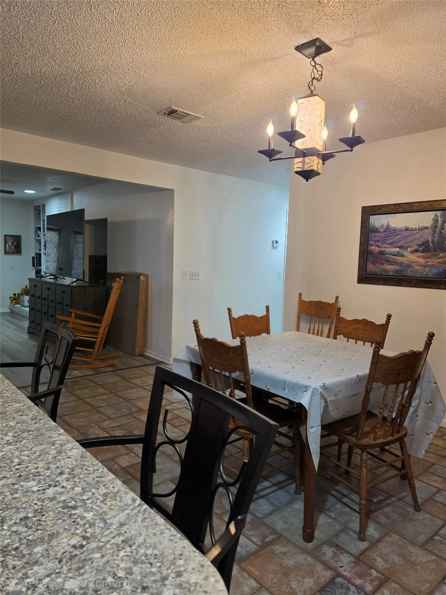 Dining area featuring a four-light chandelier, tiled flooring, and an open pass-through to an additional living space