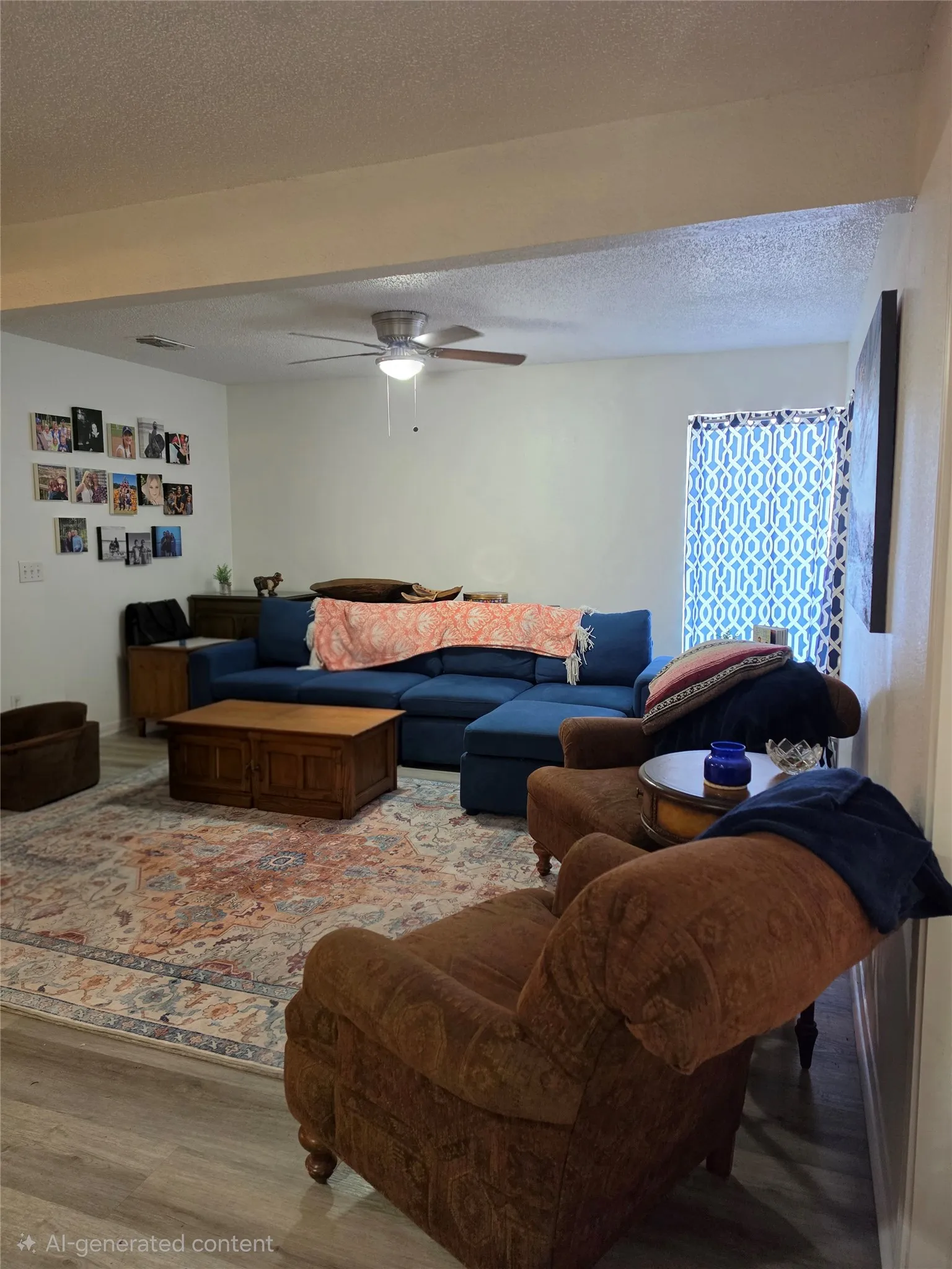 Open-concept living area featuring wood-finish flooring, a ceiling fan with integrated lighting, and patterned window coverings
