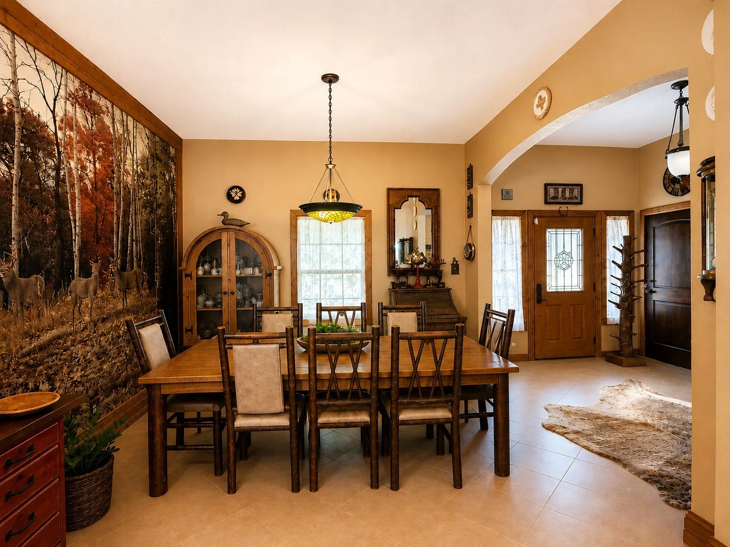Formal dining space featuring tile flooring and a decorative arched entryway