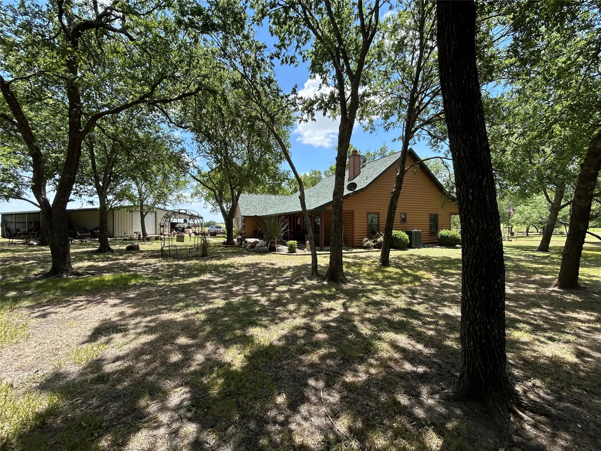Wo-sided residence with green roof surrounded by mature trees