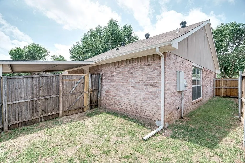 Brick exterior with a gabled roof and white gutters