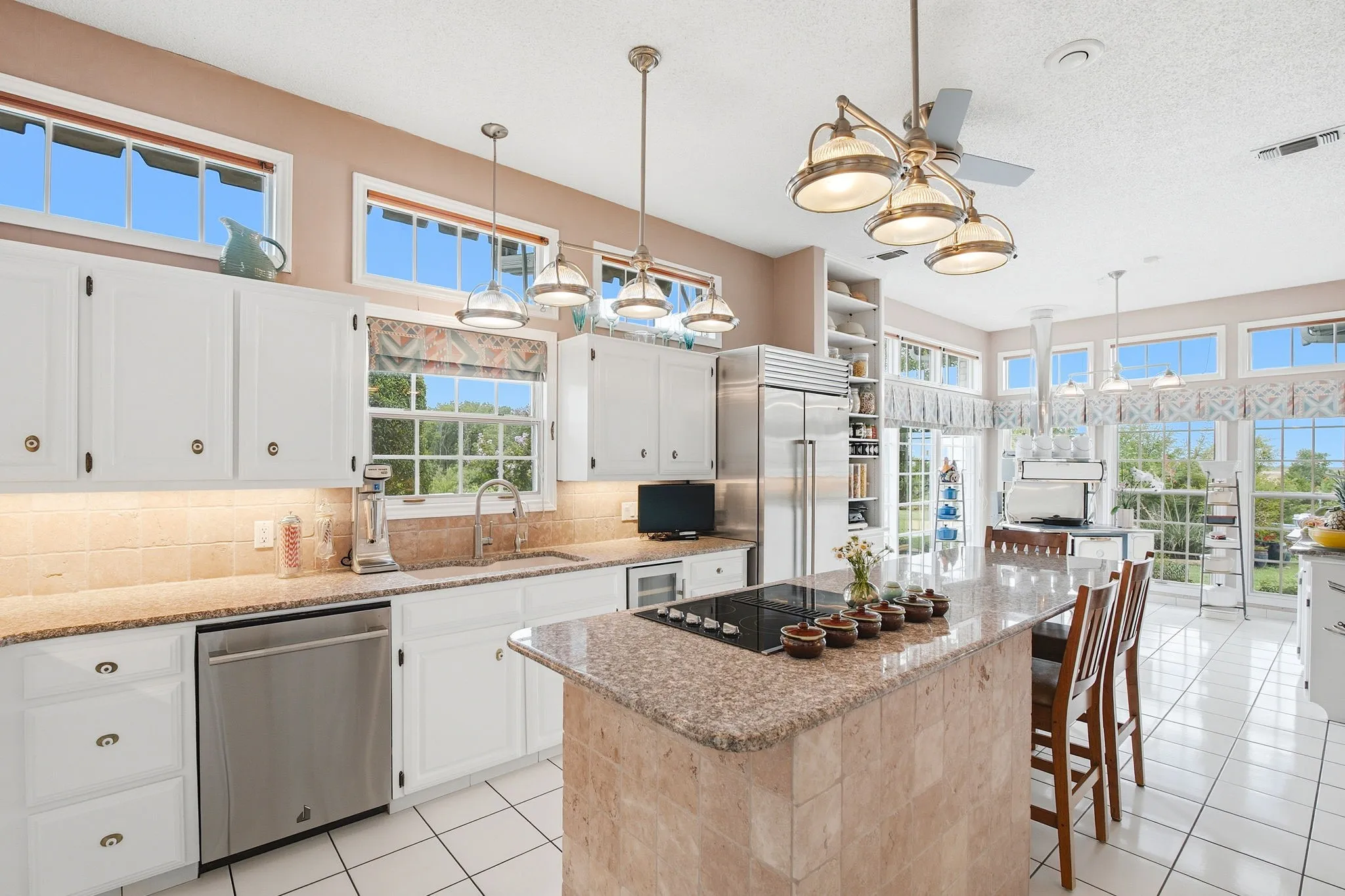 The open Gourmet kitchen offers Jenn-Aire appliances - cooktop, double SS convection ovens, and dishwasher. A subzero refrigerator-freezer and additional 2 Sub Zero refrigerators in the spacious utility room.  The extensive countertops and island are of 1.5 inch slab and imported 6 inch square Italian tumbled marble on three sides of the island base. The flooring is imported Portugal ceramic tile which flows to the utility and pantry area.  Enjoy the view from the many windows as you prepare meals and dine. Kitchen and Bathrooms hot water heaters installed by my master plumber, Dan Williams, at Sisemore Plumbing, Pottsboro, TX
phones: 803-893-0891
Carrie and Brad Sisemore, owners