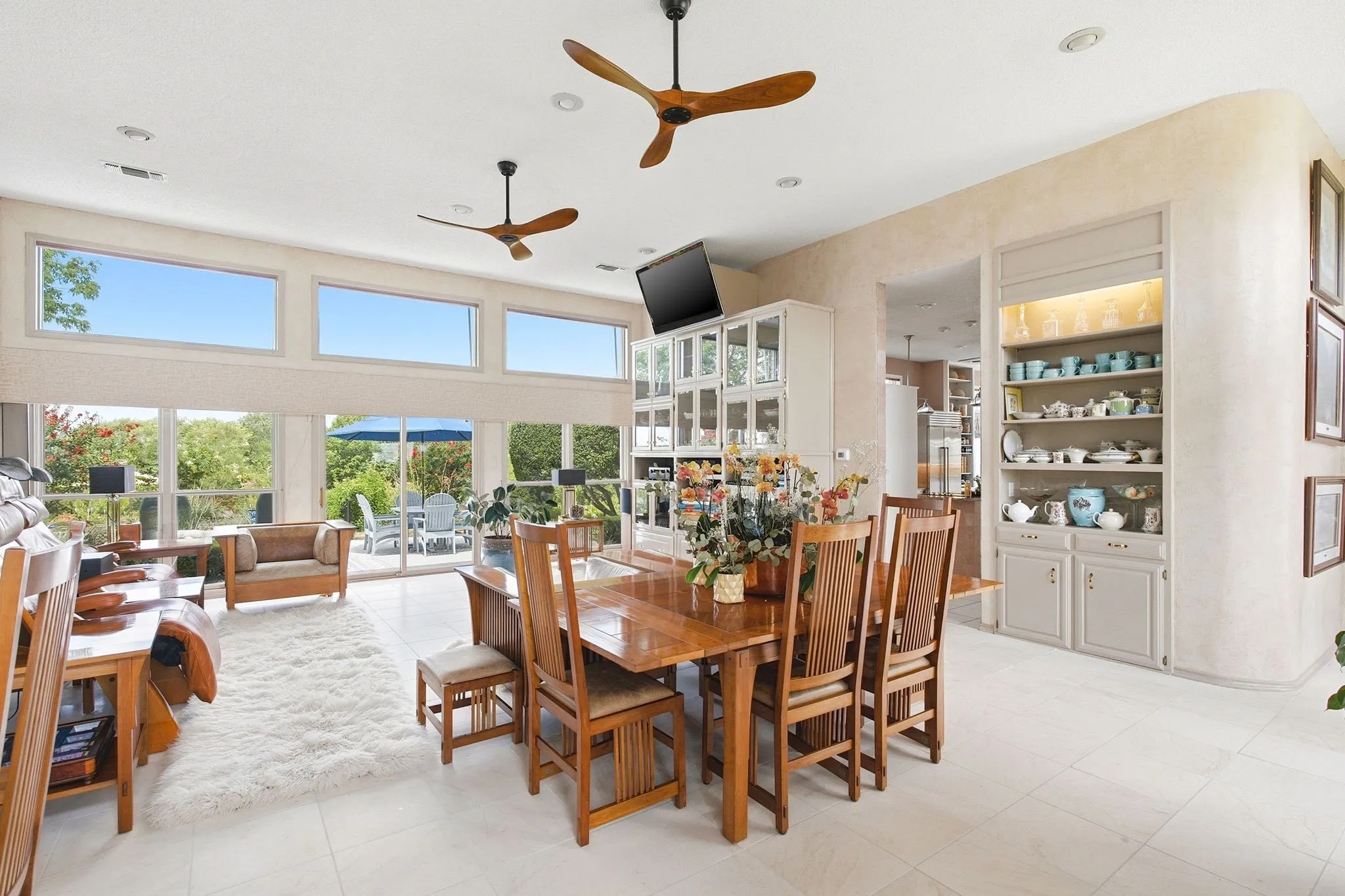 The dining room - living room is designed as a large great room.  Built-in cabinets offer display and storage area.  All rooms in the house have ceiliing fans.  The home is filled with natural lighting and is bright.