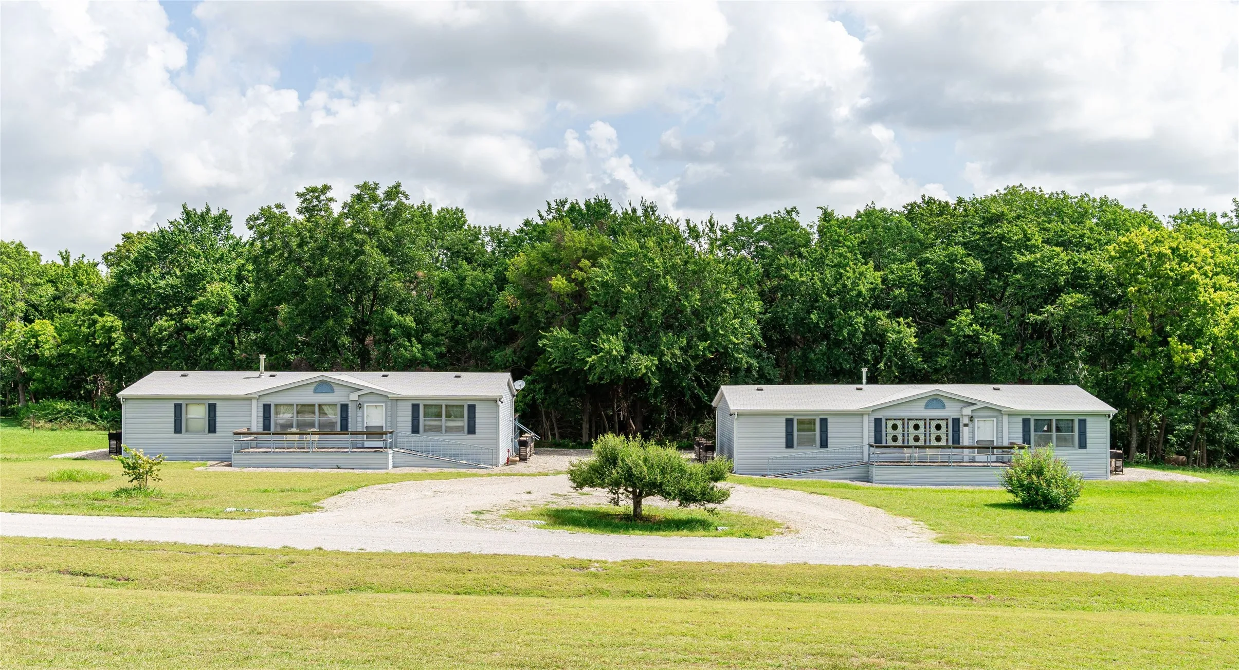 Two approximately 1,568 sf each per tax records, 3 bedrooms, 2 bath guesthouses with kitchen and living room in each structure.  These have served as a private chapel and very limited guest use.  They have been well cared for with quality roofing and foundation inspection.  There are front and back porches and mature tree view off the decks. Each guest house have kitchen appliances, washers & dryers that will remain. Each guest house has Dish Satellites and the main house has one Satellite Dish.
