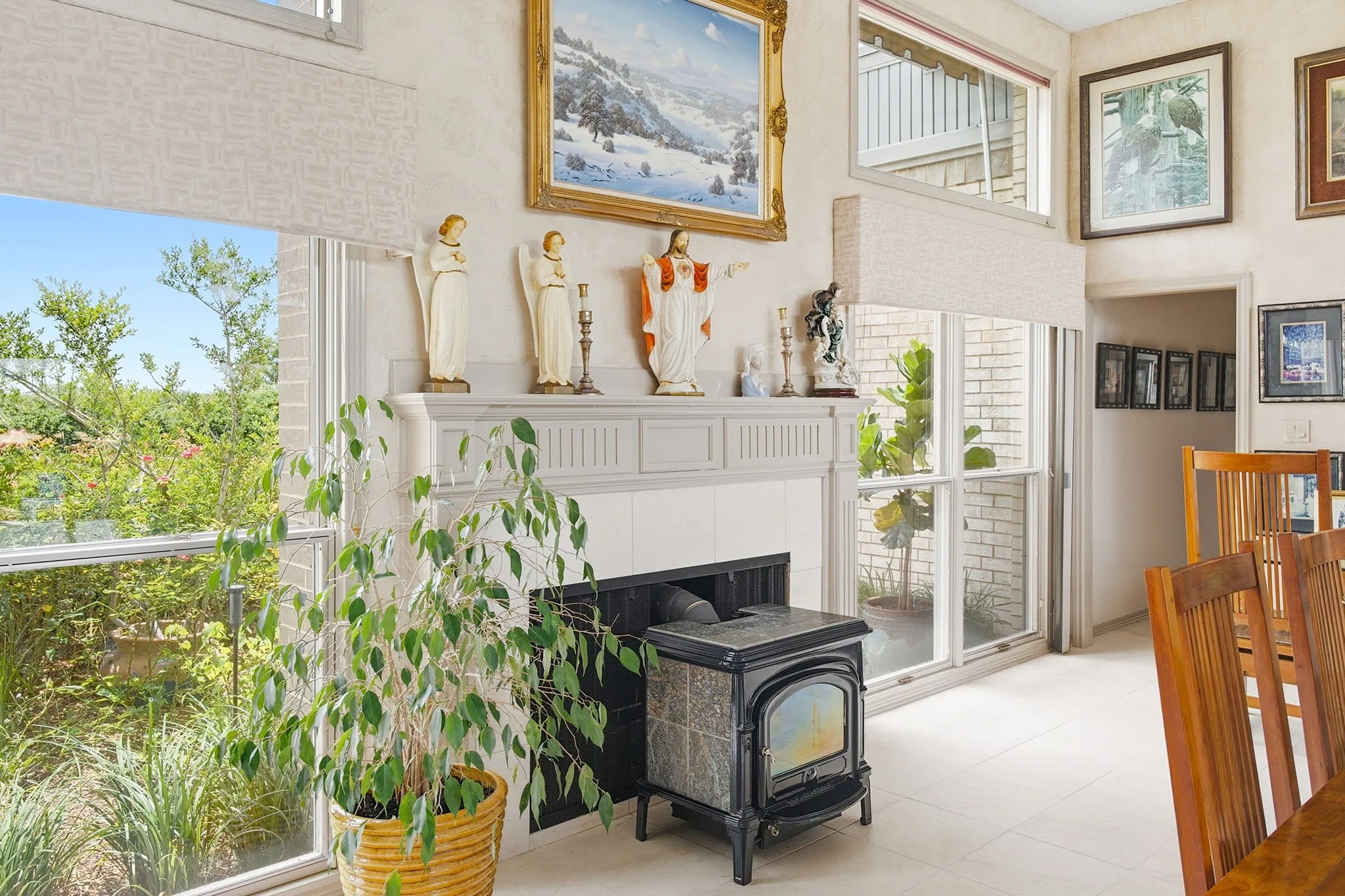 The living room has aceramic finish on the fireplace & special wood burning stove that can be easily removed if desired. The fireplace with Hearthstone Vermont soapstone wood burning stove has a stainless steel double walled flue set inside the fireplace fire brick flue.  The stove can hold wood heat up to 18 hours. No soot, no fumes and ideal for those who have allergies. Note the outside beauty is captured through the windows throughtout the home.