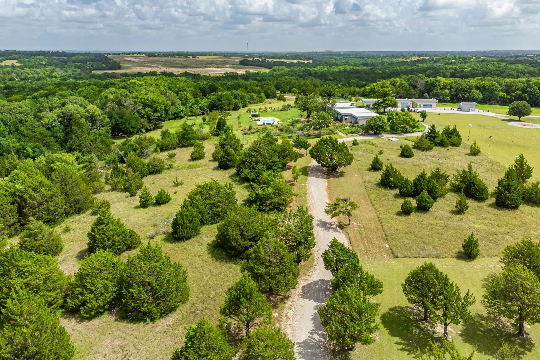 From the entry off of Harrell Road there is a security gate that is approximately 1 mile long & 40 feet wide, gravel drive that leads to the second set of electric security gates. The is part of the property, not an easement.  The main house has paved open parking areas.  In addition to this entry private road, there is an approximate mile long walking/jogging through the woods and parts of the estate.